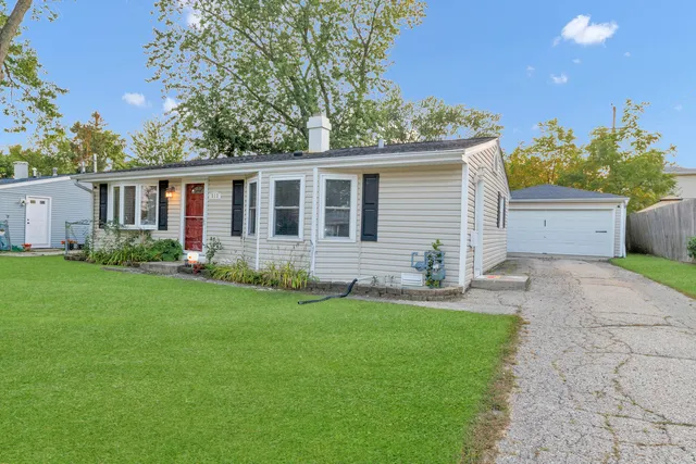 a front view of house with yard and green space