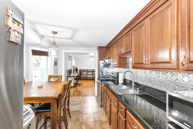 a kitchen with sink refrigerator and cabinets