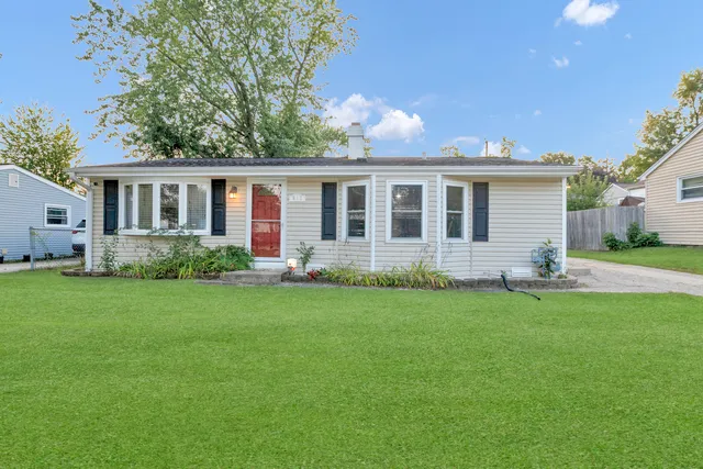 a front view of house with yard and green space