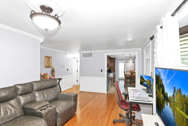a living room with furniture and a mirror