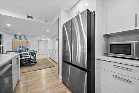 a kitchen with stainless steel appliances kitchen island granite countertop a sink a stove and cabinets