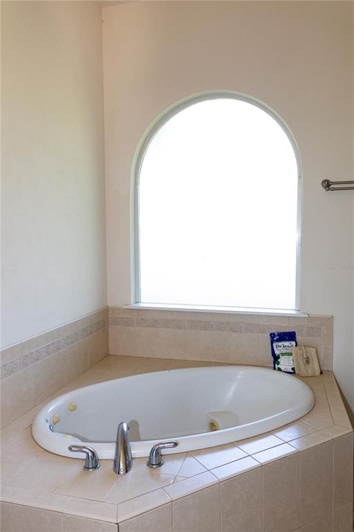 6494 Northwest 109th Place Alachua, FL 32615 - Photo 11 of 19 a bath tub sitting in a bathroom