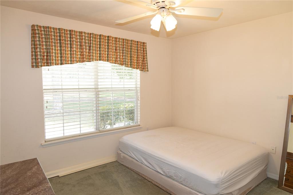 6494 Northwest 109th Place Alachua, FL 32615 - Photo 17 of 19 a bed sitting in a bedroom next to a window