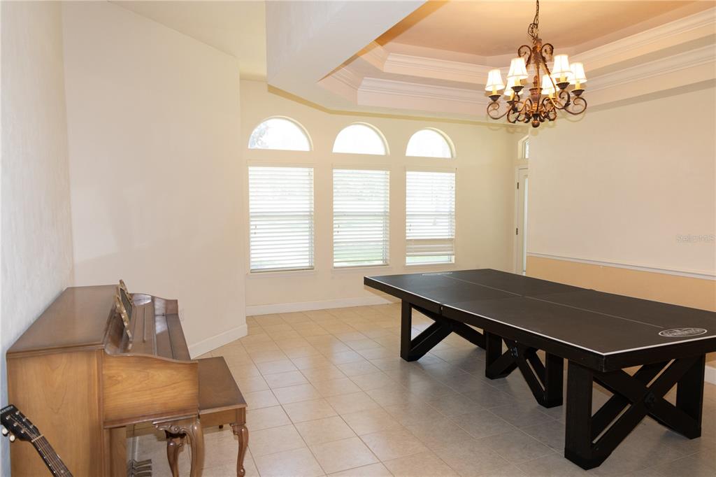 6494 Northwest 109th Place Alachua, FL 32615 - Photo 7 of 19 a view of a dining room with furniture and a chandelier