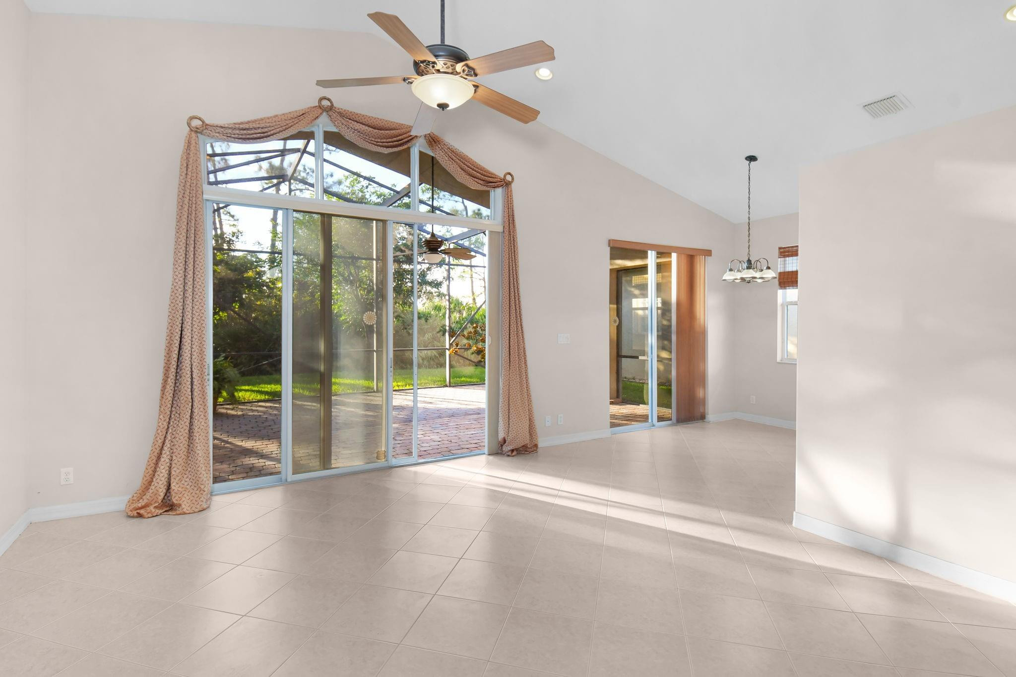 7084 Southeast Cricket Court Stuart, FL 34997 - Photo 13 of 60 LARGE SLIDING DOORS IN LIVING ROOM