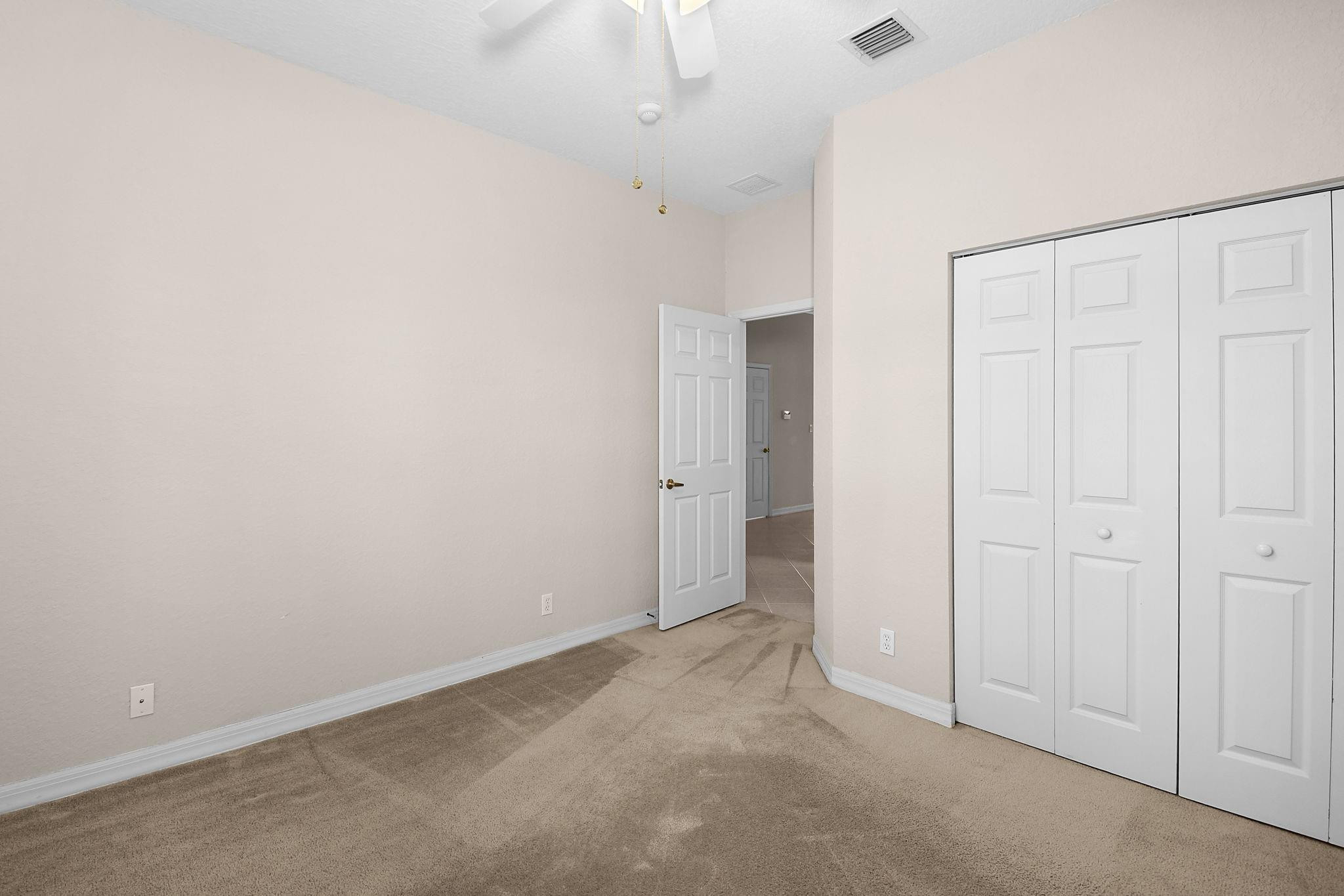 7084 Southeast Cricket Court Stuart, FL 34997 - Photo 25 of 60 FRONT BEDROOM