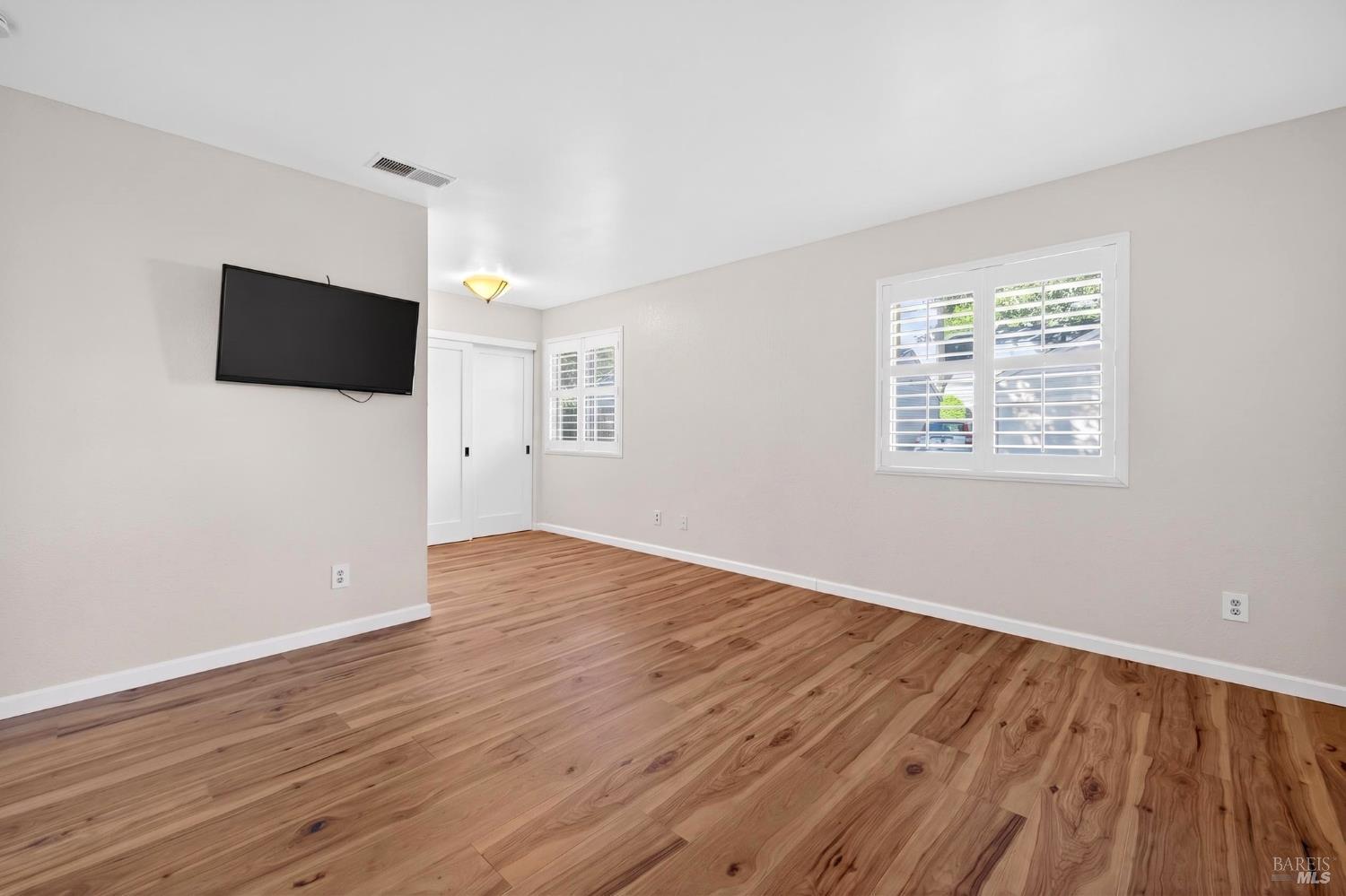 2757 Lakeview Drive Santa Rosa, CA 95405 - Photo 17 of 54 an empty room with wooden floor and windows