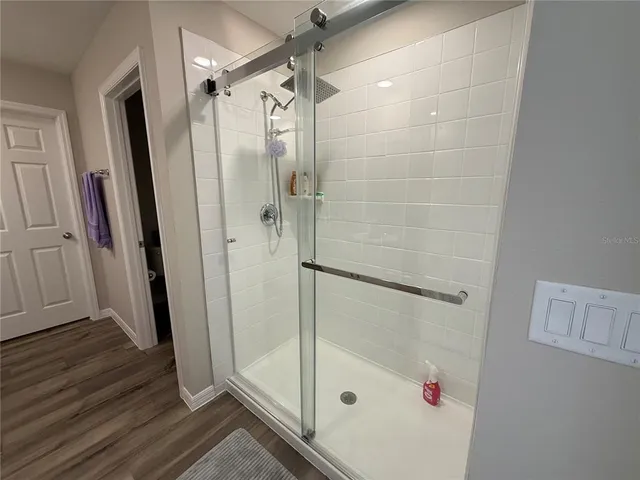 a bathroom with a glass shower door