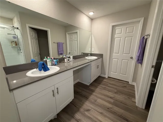 a bathroom with a double vanity sink and a mirror
