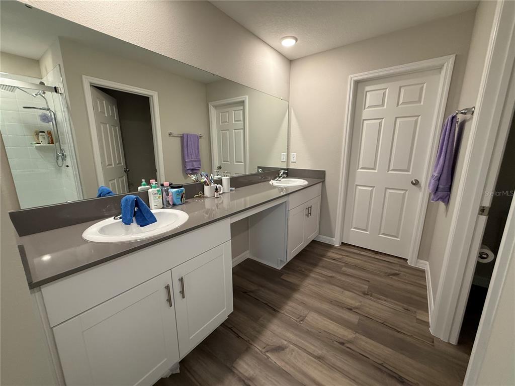 3464 Dahlia Drive Haines City, FL 33844 - Photo 22 of 41 a bathroom with a double vanity sink and a mirror