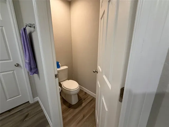a white toilet sitting next to a sink
