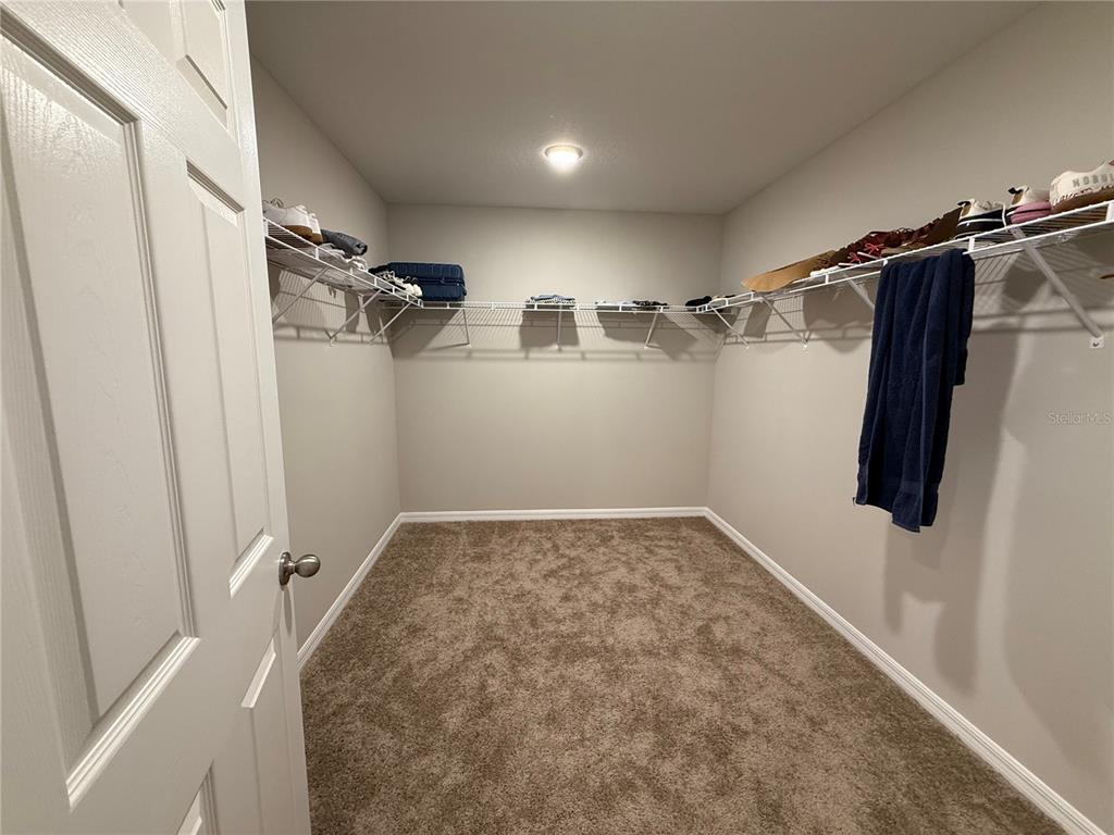 3464 Dahlia Drive Haines City, FL 33844 - Photo 25 of 41 a view of walk in closet with clothes and shoes