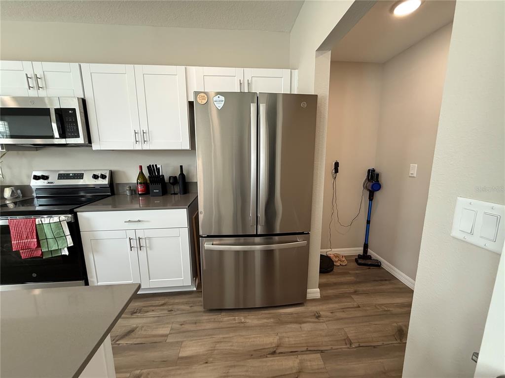 3464 Dahlia Drive Haines City, FL 33844 - Photo 40 of 41 a kitchen with a refrigerator and a stove top oven