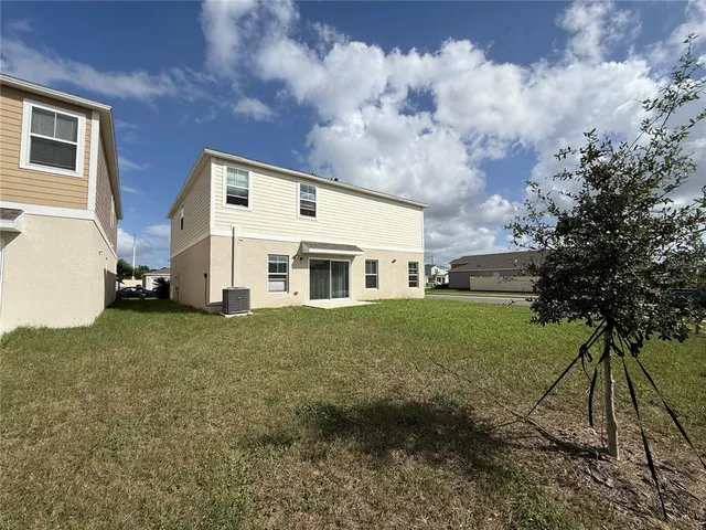 a big house with a big yard and large trees