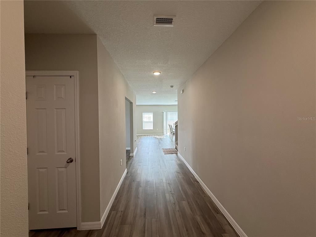 3464 Dahlia Drive Haines City, FL 33844 - Photo 9 of 41 a view of a hallway with wooden floor