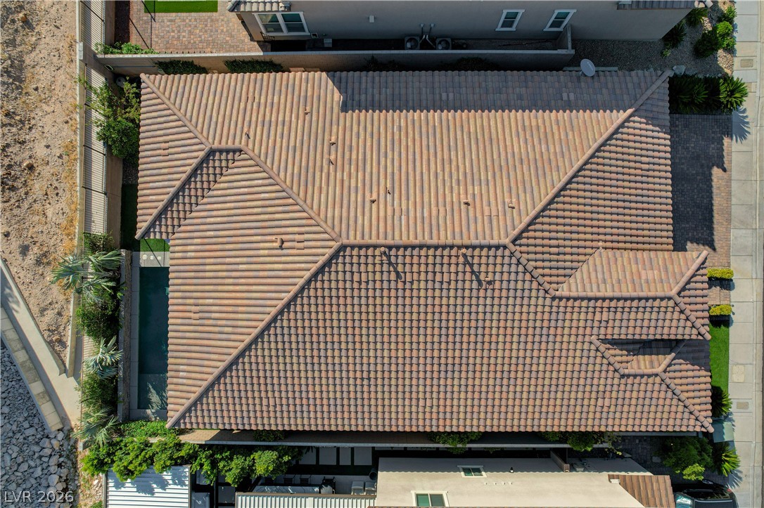 3943 Reyes Avenue Las Vegas, NV 89141 - Photo 71 of 95 An aerial perspective showcases a home with a terracotta tile roof and private pool area.