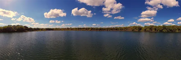 a view of a lake in middle of forest