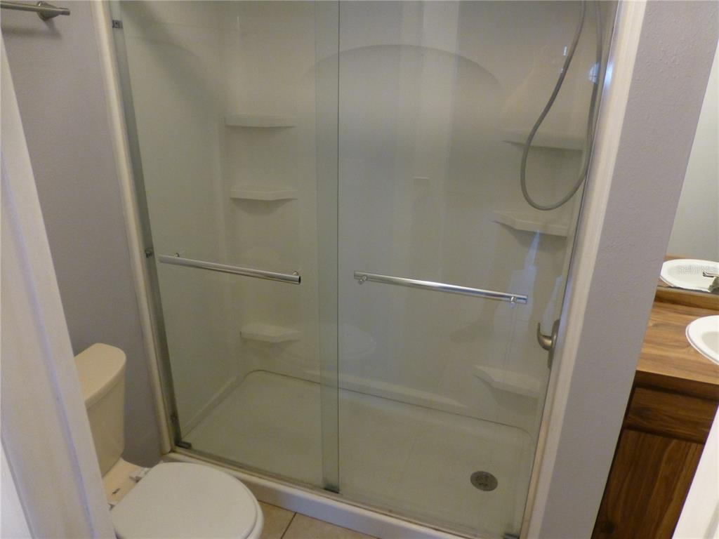 1890 Wolford Road, Unit 5 Clearwater, FL 33760 - Photo 16 of 29 a bathroom with a toilet and a shower