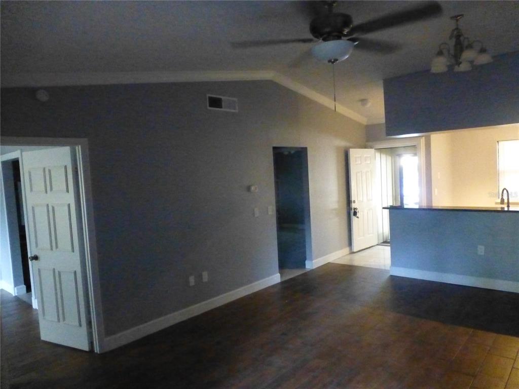 1890 Wolford Road, Unit 5 Clearwater, FL 33760 - Photo 29 of 29 an empty room with wooden floor and windows