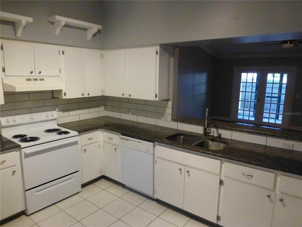 1890 Wolford Road, Unit 5 Clearwater, FL 33760 - Photo 5 of 29 a kitchen that has a sink and a stove