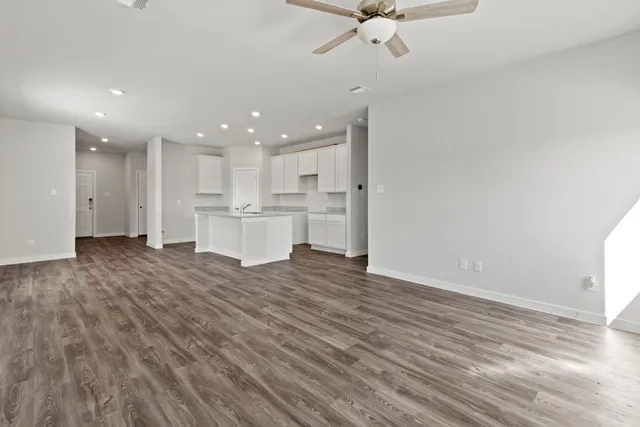a view of kitchen view with wooden floor and cabinets