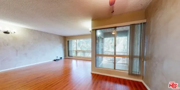 a view of room with window and wooden floor