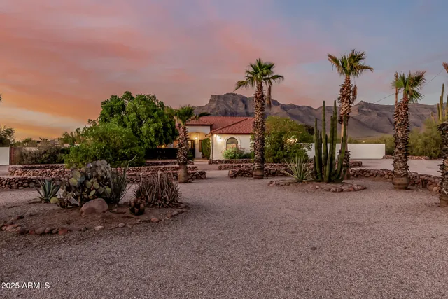 a view of a house with a yard and sitting area