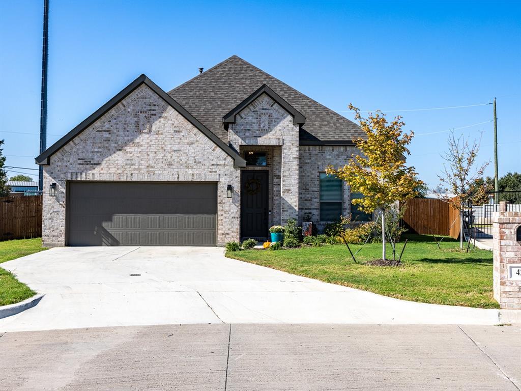 425 Monarch Way Justin, TX 76247 - Photo 1 of 25 a front view of a house with a yard and garage