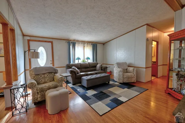 a view of a balcony with floor to ceiling window and tree