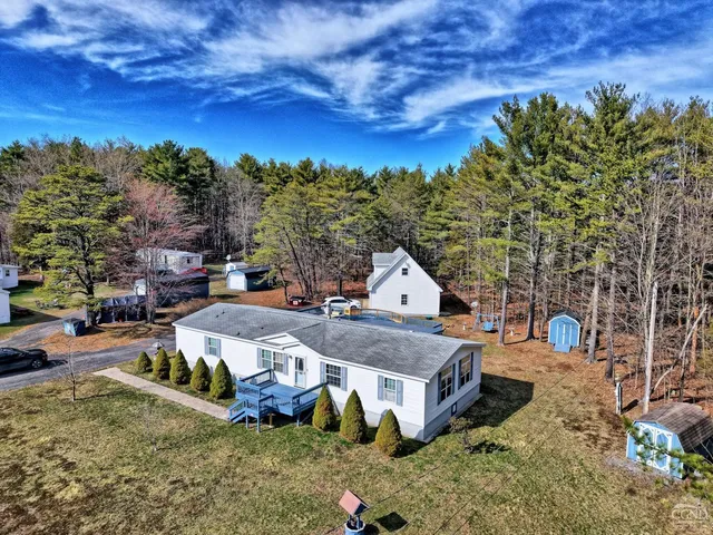 a front view of a house with swimming pool and porch