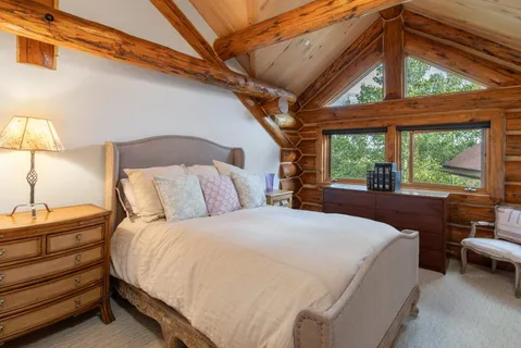 a spacious bedroom with a bed and a large window