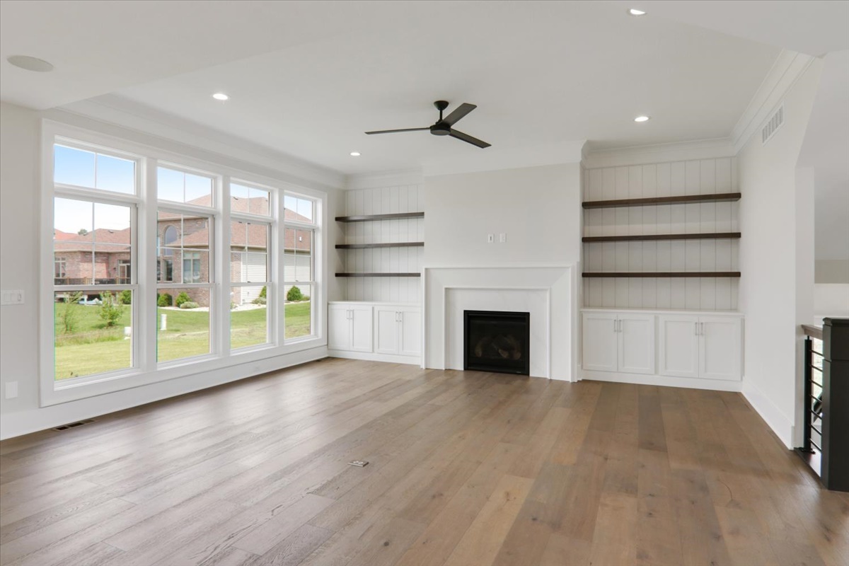 604 Cayman Way Savoy, IL 61874 - Photo 12 of 82 a view of empty room with wooden floor and fireplace