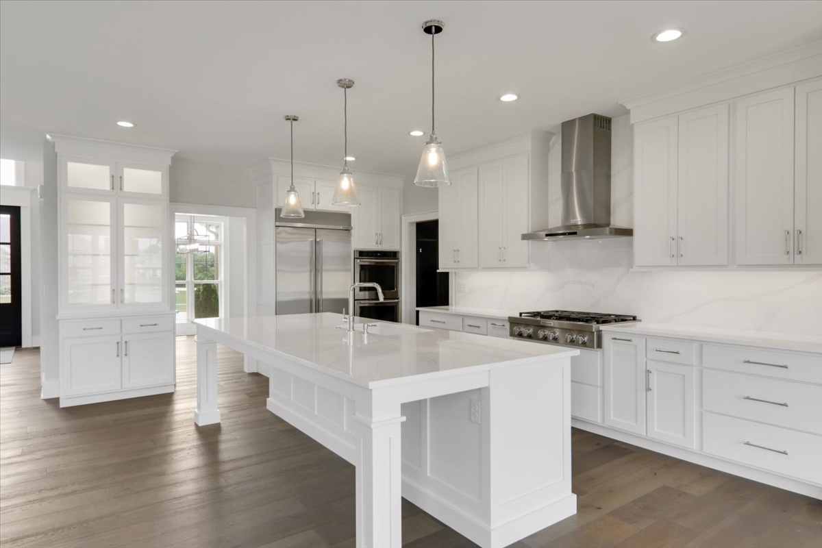 604 Cayman Way Savoy, IL 61874 - Photo 14 of 82 a large white kitchen with lots of counter space wooden floor and stainless steel appliances