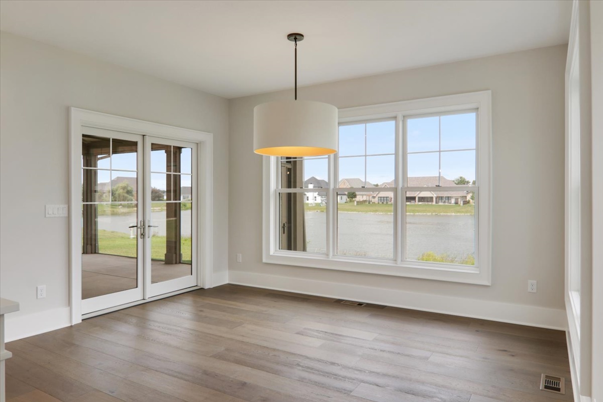 604 Cayman Way Savoy, IL 61874 - Photo 16 of 82 an empty room with wooden floor and windows