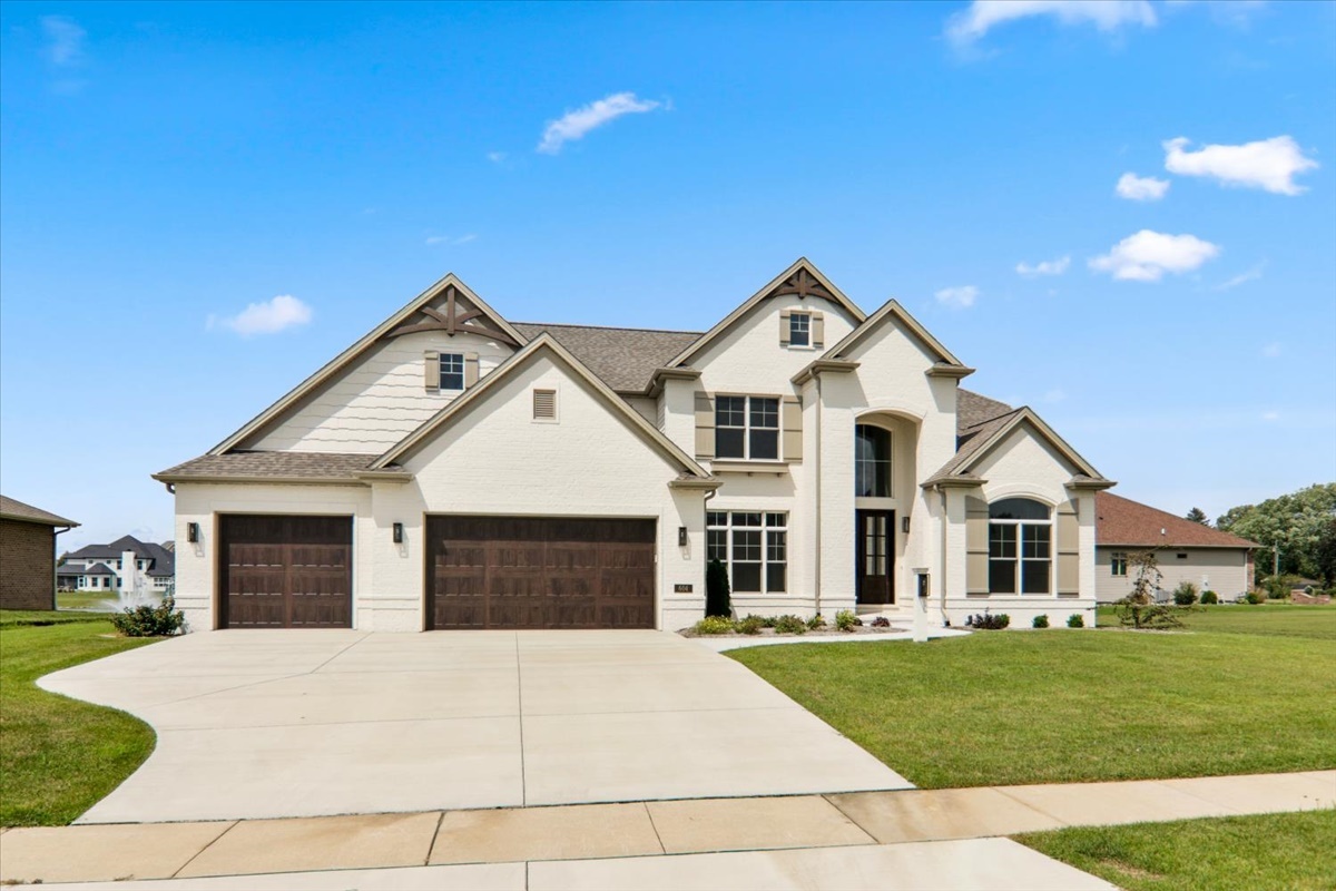 604 Cayman Way Savoy, IL 61874 - Photo 2 of 82 a front view of a house with a garden and yard