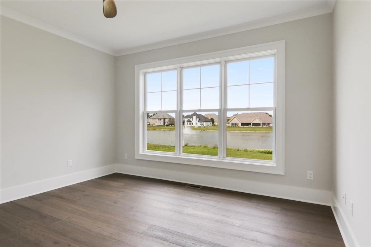 604 Cayman Way Savoy, IL 61874 - Photo 21 of 82 an empty room with wooden floor and windows