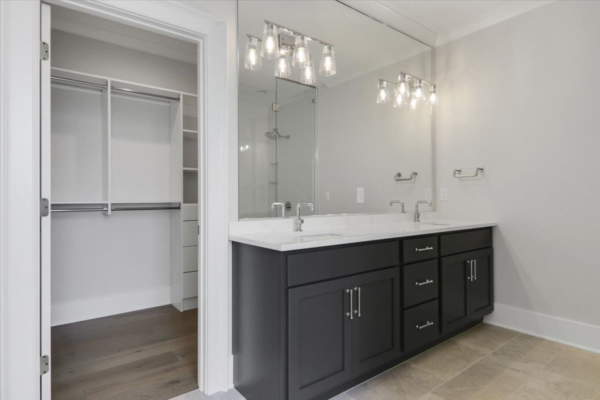 604 Cayman Way Savoy, IL 61874 - Photo 32 of 82 a bathroom with a double vanity sink and a mirror