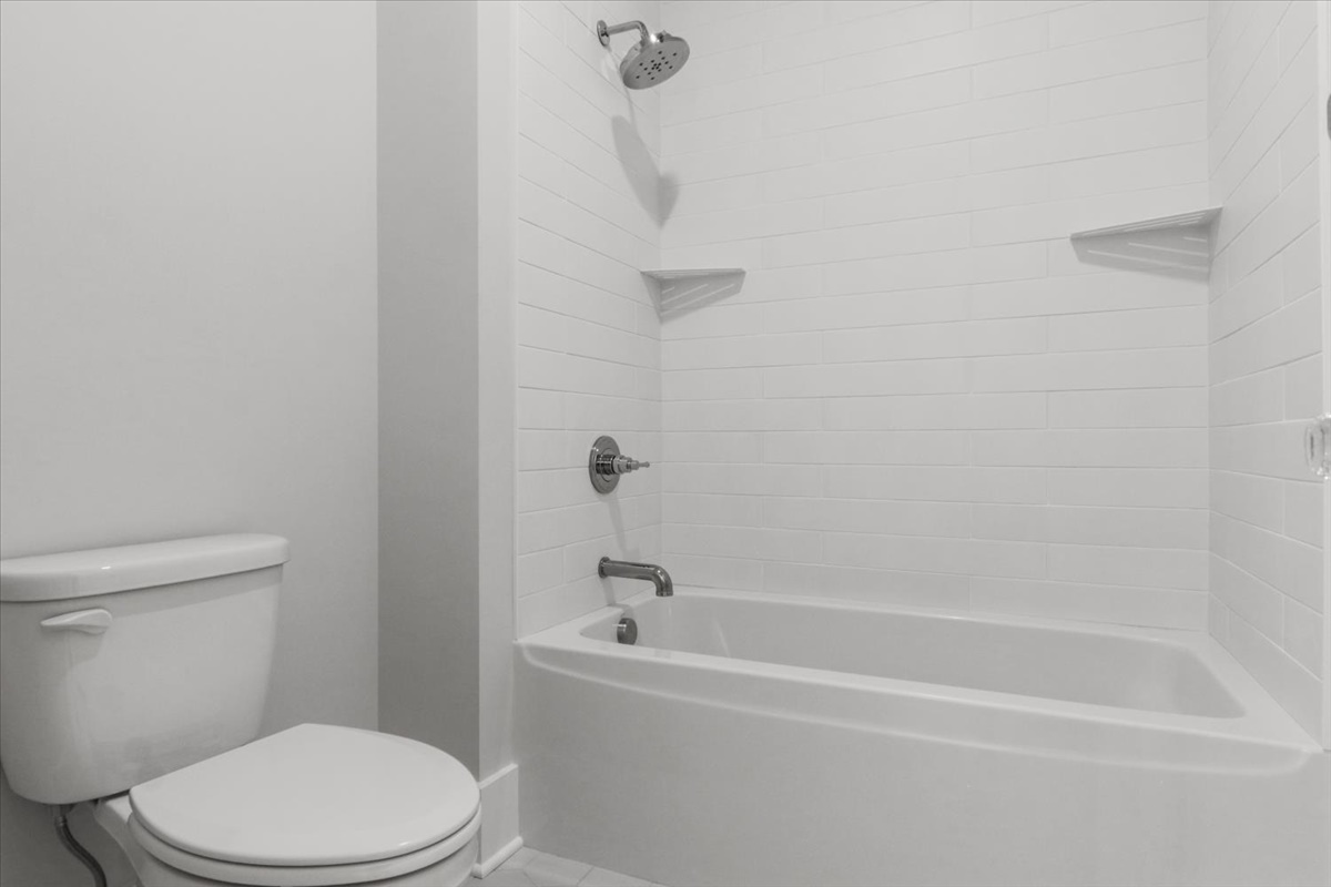 604 Cayman Way Savoy, IL 61874 - Photo 39 of 82 a white toilet and tub sitting next to a bathroom sink