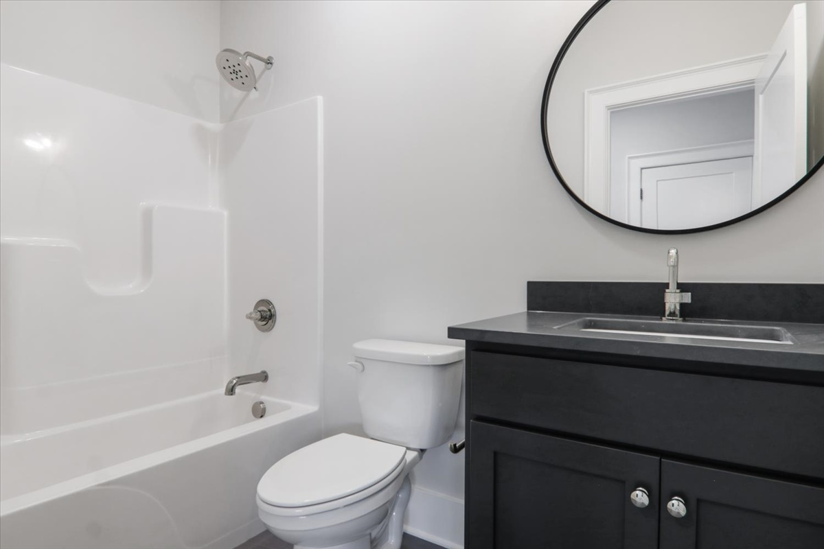 604 Cayman Way Savoy, IL 61874 - Photo 44 of 82 a bathroom with a sink a toilet and a mirror