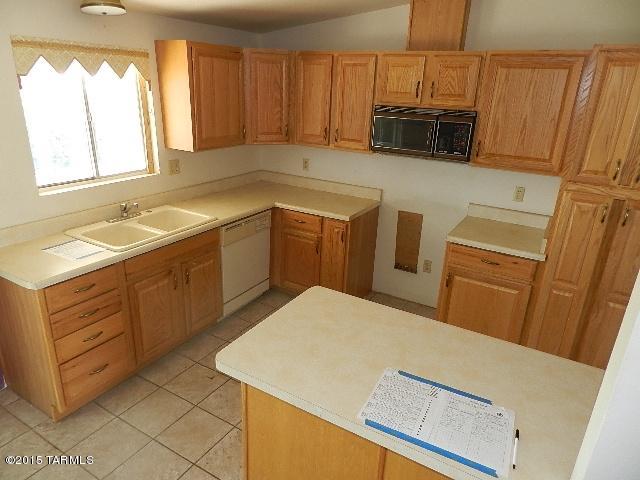 2007 West Saxony Road Tucson, AZ 85713 - Photo 9 of 25 a kitchen with a sink a stove and microwave