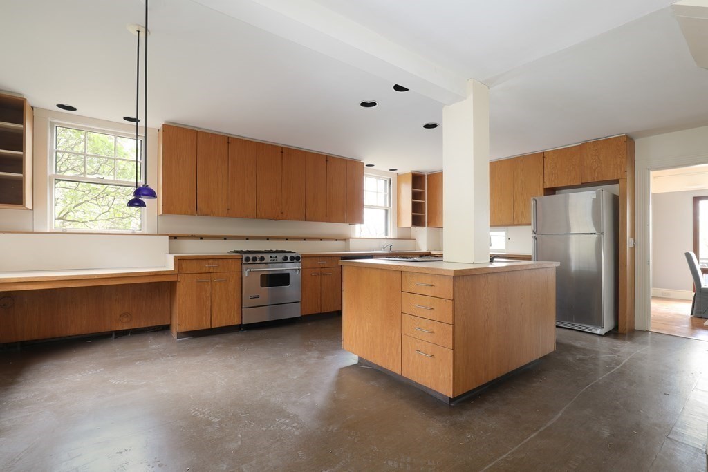 16 Percy Road Lexington, MA 02421 - Photo 17 of 31 a kitchen with stainless steel appliances a refrigerator a sink dishwasher a oven with white cabinets and wooden floor