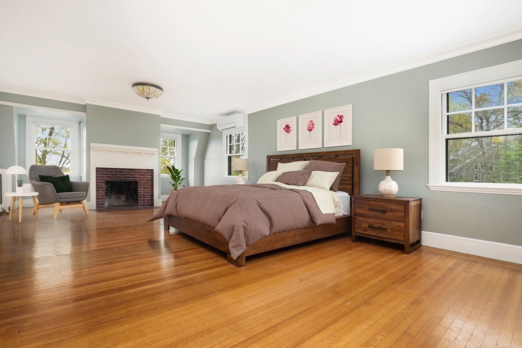 16 Percy Road Lexington, MA 02421 - Photo 20 of 31 a bedroom with a bed and a fireplace
