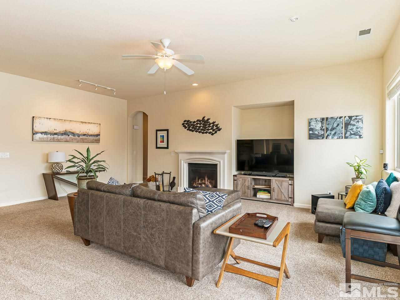 10175 Gold Mine Drive Reno, NV 89521 - Photo 6 of 24 a living room with furniture a flat screen tv and a fireplace