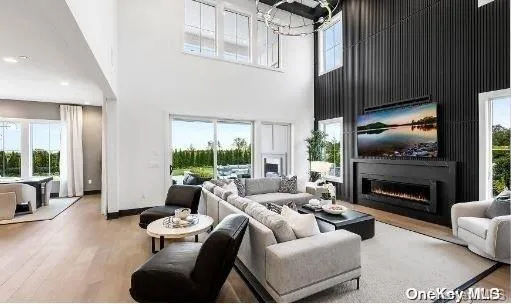 a living room with furniture fireplace and a floor to ceiling window