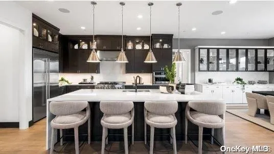 a large kitchen with a table and chairs