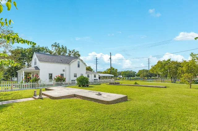 a view of a house with swimming pool and a yard
