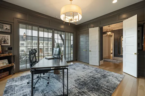 a living room with furniture large window and a fireplace
