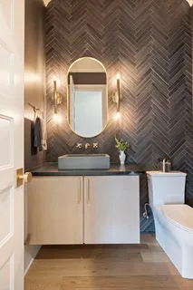 a open kitchen with stainless steel appliances granite countertop a stove top oven a sink dishwasher a dining table and chairs with wooden floor