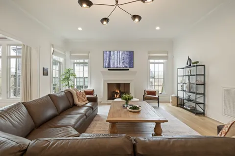 a kitchen with a sink and a large mirror next to a window
