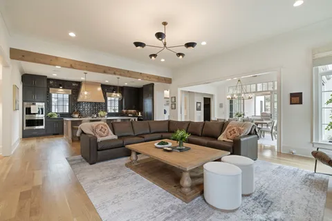 a large kitchen with kitchen island a stove a sink a center island and couches